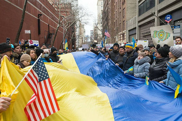 group demonstration with Ukrainian and U.S. flags