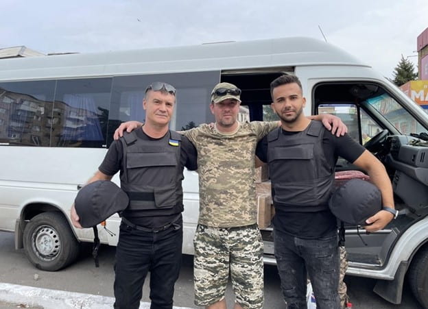 Bringing supplies to soldiers on the frontlines in Donbas. The author is on the right. August 2022 (photo by the author).